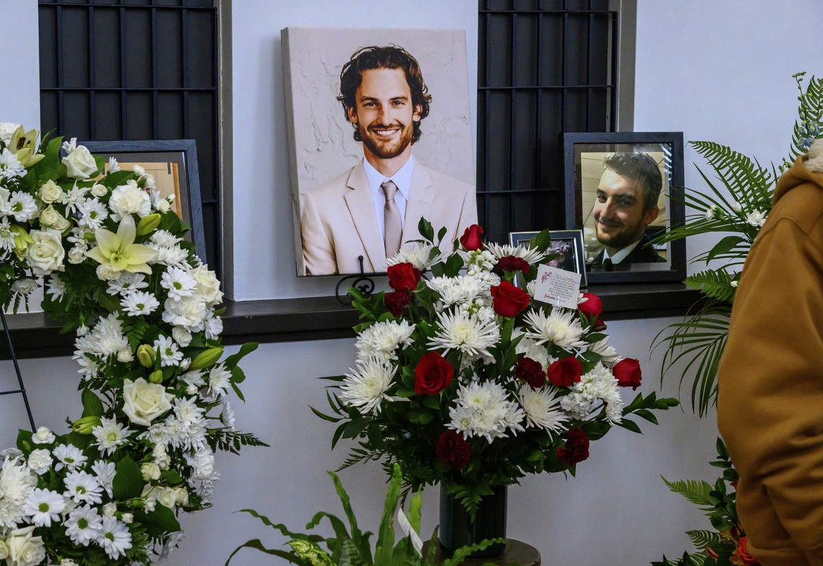 Photos of Adam Johnson line the ticket window booth at the Hibbing Memorial Building, in Hibbing, Minn., Monday, Nov. 6, 2023, as part of a celebration of life ceremony for the hockey player and Hibbi ...
