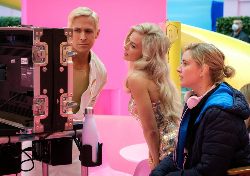 This image released by Warner Bros. Pictures shows actors Ryan Gosling, left, Margot Robbie, center, with director Greta Gerwig on the set of &quot;Barbie.&quot; (Jaap Buitendijk/Warner Bros. Pictures ...