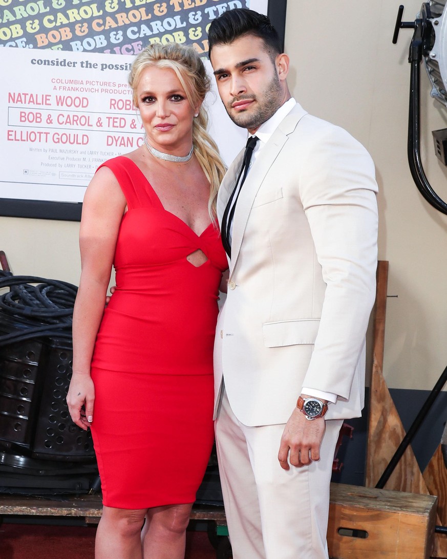 FILE - Britney Spears Is Engaged to Sam Asghari After Nearly 5 Years Together. Singer Britney Spears wearing a Nookie dress and boyfriend/personal trainer Sam Asghari arrive at the World Premiere Of S ...