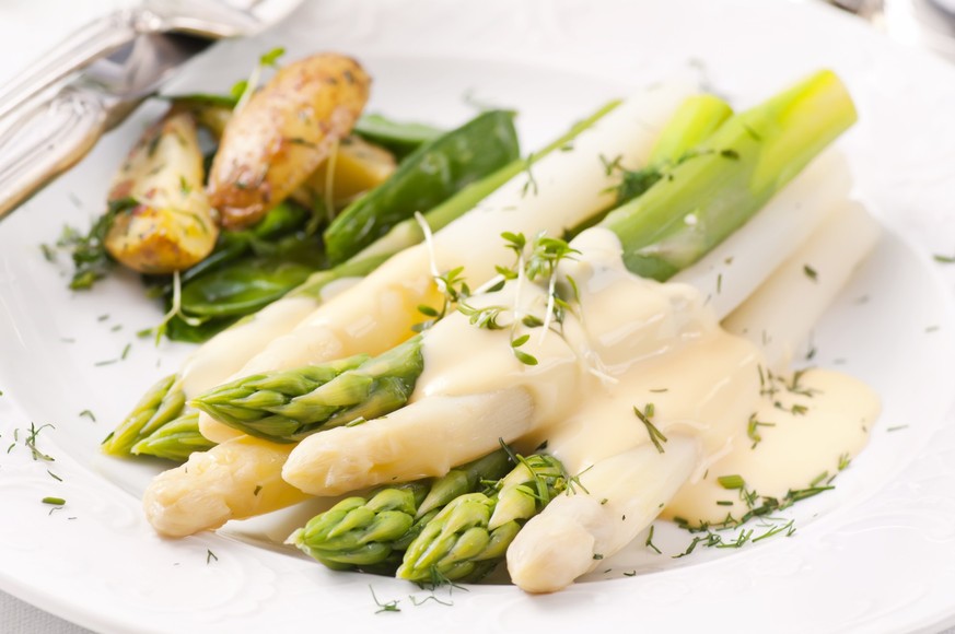 Asparagus with potatoes as closeup on a white plate