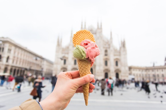 Travel, Italy and holidays concept - Ice cream in front of Milan Cathedral Duomo. Model Released Property Released xkwx italy, milan, duomo, gelato, ice-cream, cathedral, white, architecture, building ...