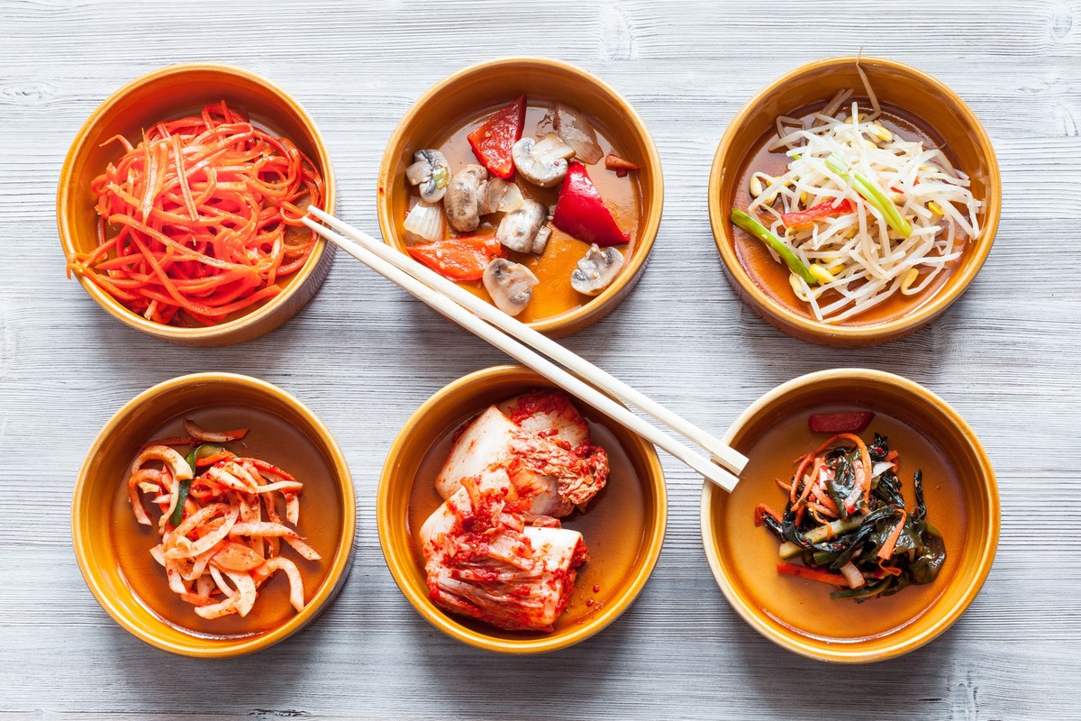 chopsticks above various appetizers in bowls