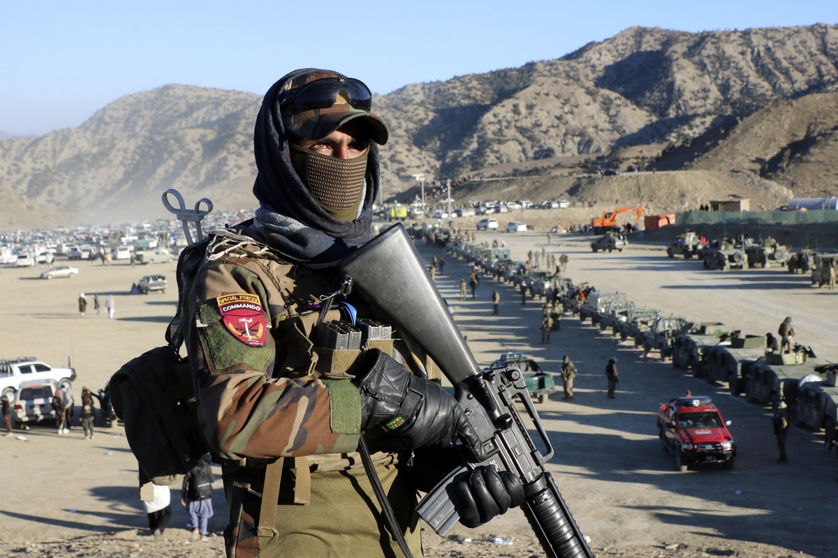 Taliban fighters stand guard during the funeral prayers of Khalil Haqqani, the minister for refugees and repatriation, during his funeral procession in eastern Paktia province, Afghanistan, Thursday,  ...