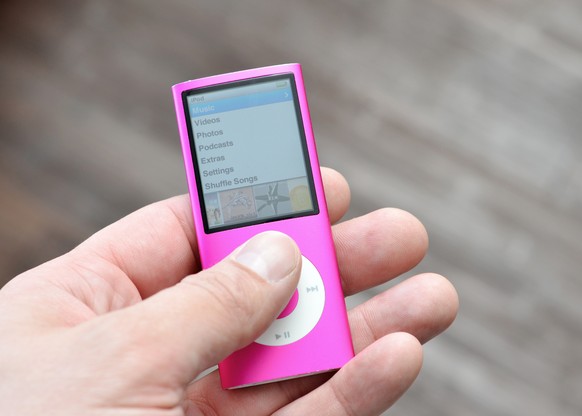 &quot;Vancouver, Canada -- September 12, 2012:Close up of a man&#039;s hand holding an older version of the iPod Nano from Apple Inc. This is the Fourth Generation of the Portable Media Players.&quot;