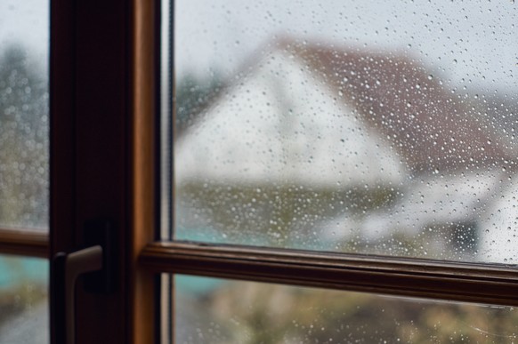 Raindrops at the window, close up view, weather in march