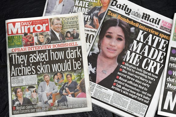 UK tabloid newspapers showing front page headlines of Oprah Winfrey&#039;s interview with Prince Harry and Meghan Duchess of Sussex which broadcast on CBS on 07 March 2021. London, UK on 8 March 2021. ...