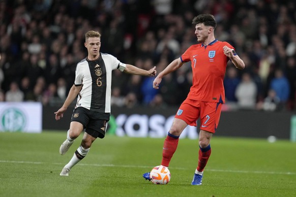 Germany&#039;s Joshua Kimmich, left, challenges for the ball with England&#039;s Declan Rice during the UEFA Nations League soccer match between England and Germany at Wembley stadium in London, Monda ...