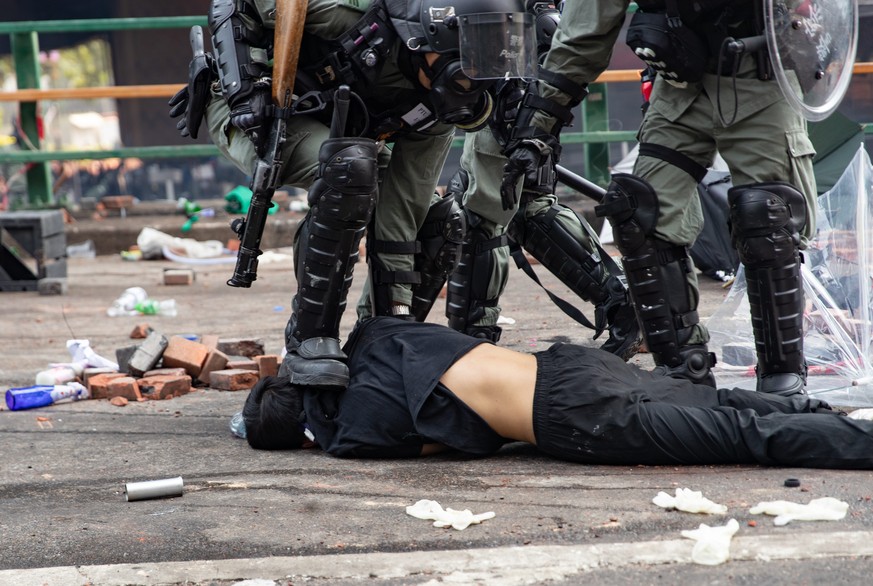 November 18, 2019, Hong Kong, China: A police officer steps on the head of a protester during the demonstration..Police surround the Polytechnic University after pro-democratic protesters blocked the  ...