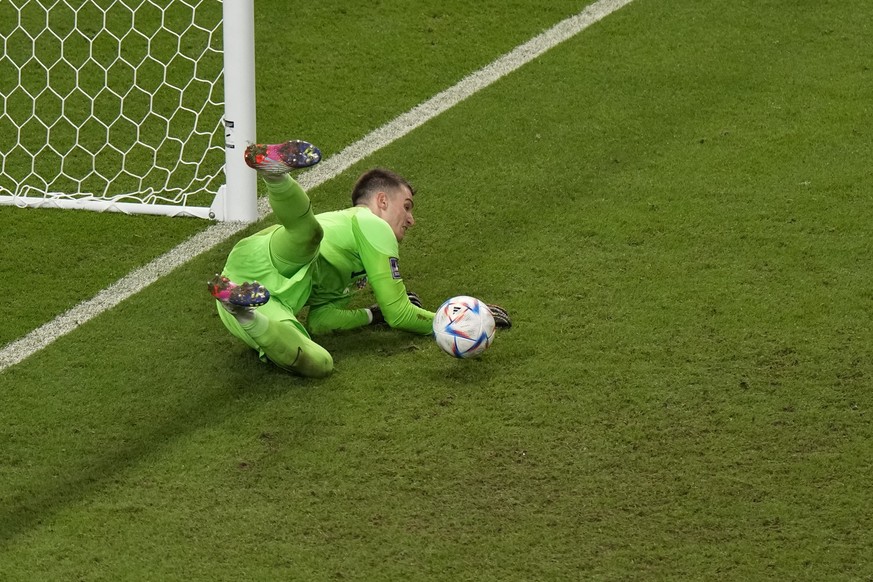 Croatia&#039;s goalkeeper Dominik Livakovic saves a penalty kick by Japan&#039;s Takumi Minamino during the World Cup round of 16 soccer match between Japan and Croatia at the Al Janoub Stadium in Al  ...