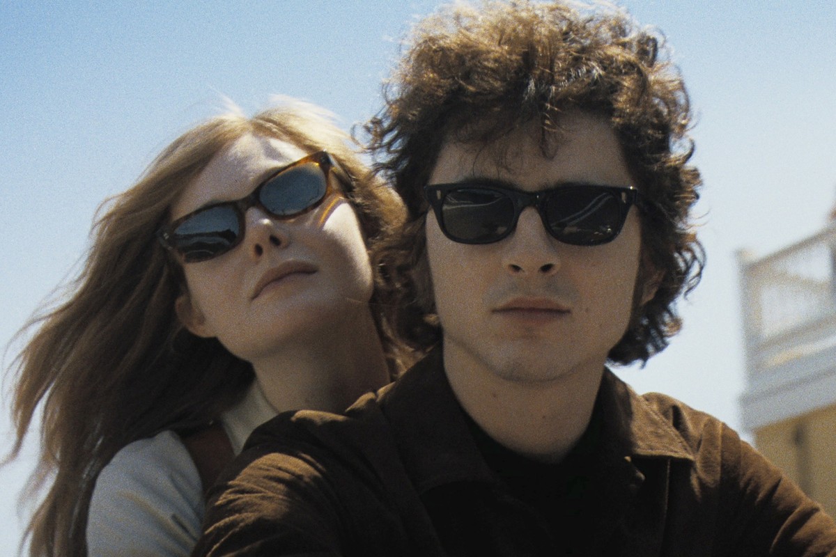 This image released by Searchlight Pictures shows Elle Fanning, left, and Timothée Chalamet in a scene from &quot;A Complete Unknown.&quot; (Searchlight Pictures via AP)