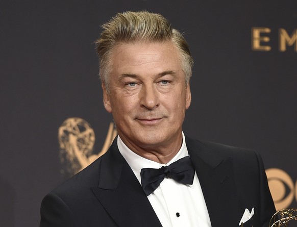 FILE - Alec Baldwin poses in the press room with the award for outstanding supporting actor in a comedy series for &quot;Saturday Night Live&quot; at the 69th Primetime Emmy Awards in Los Angeles on S ...
