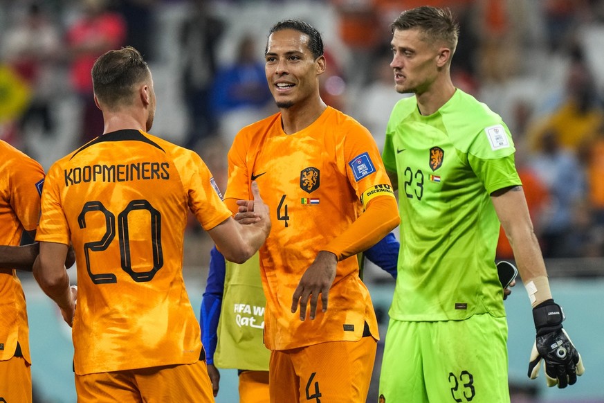 Virgil van Dijk of the Netherlands celebrates with his teammate Teun Koopmeiners of the Netherlands, left, and goalkeeper Andries Noppert of the Netherlands at the end of the match during the World Cu ...