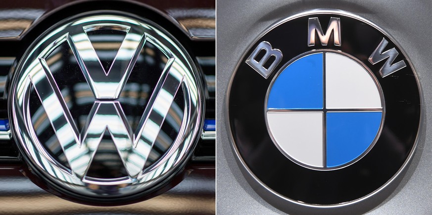 ARCHIV - 01.01.2018, ---, --: Die Logos der Automobilhersteller VW (l) und BMW (Kombo). Die EU-Kommission hat gegen die beiden deutschen Autobauer Wettbewerbsstrafen in dreistelliger Millionenhöhe ver ...