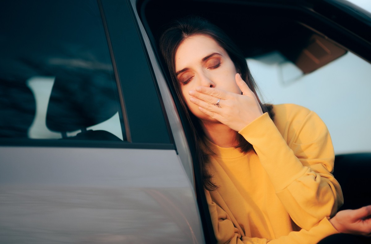 Female passenger feeling sick after a long road trip