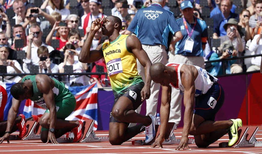 FILE - In this Aug. 4, 2012, file photo, Jamaica&#039;s Usain Bolt, center, gestures before competing in a men&#039;s 100-meter heat in the athletics competition at the Olympic Stadium during the 2012 ...