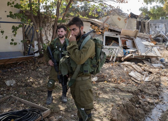 Israeli soldiers near destroyed Jewish homes in the southern Israeli community of Kibbutz Be eri on October 22, 2023. This community was attacked by Hamas infiltrators who killed some 100 people out o ...