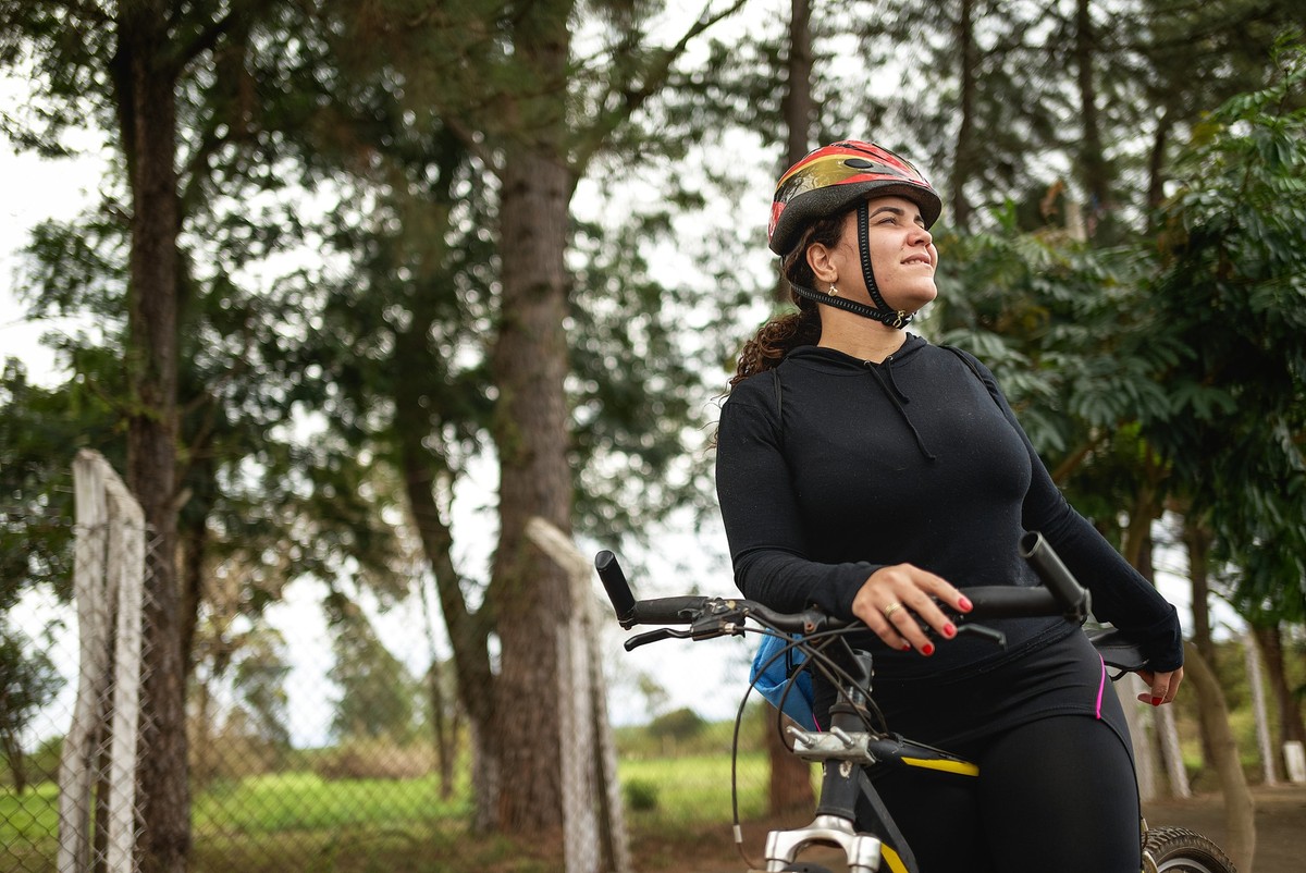 Portraits of a young Latin woman pausing her cycling to take a few pictures of the beautiful trees around her.